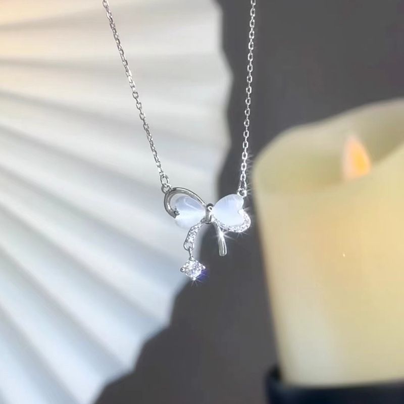Bow pendant tassel necklace with delicate drop-chain detail