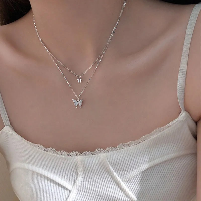 Layered butterfly pendant necklace with delicate chain detail