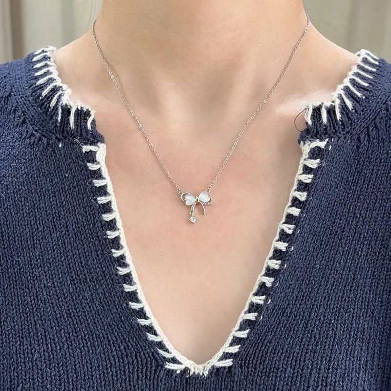 Bow pendant tassel necklace with delicate drop-chain detail