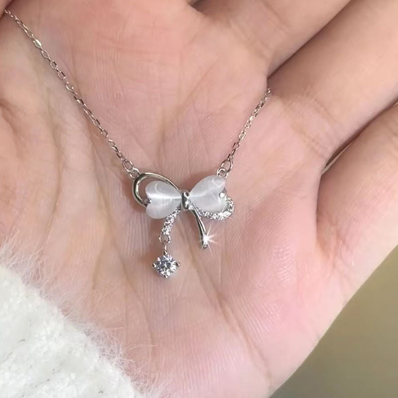 Bow pendant tassel necklace with delicate drop-chain detail
