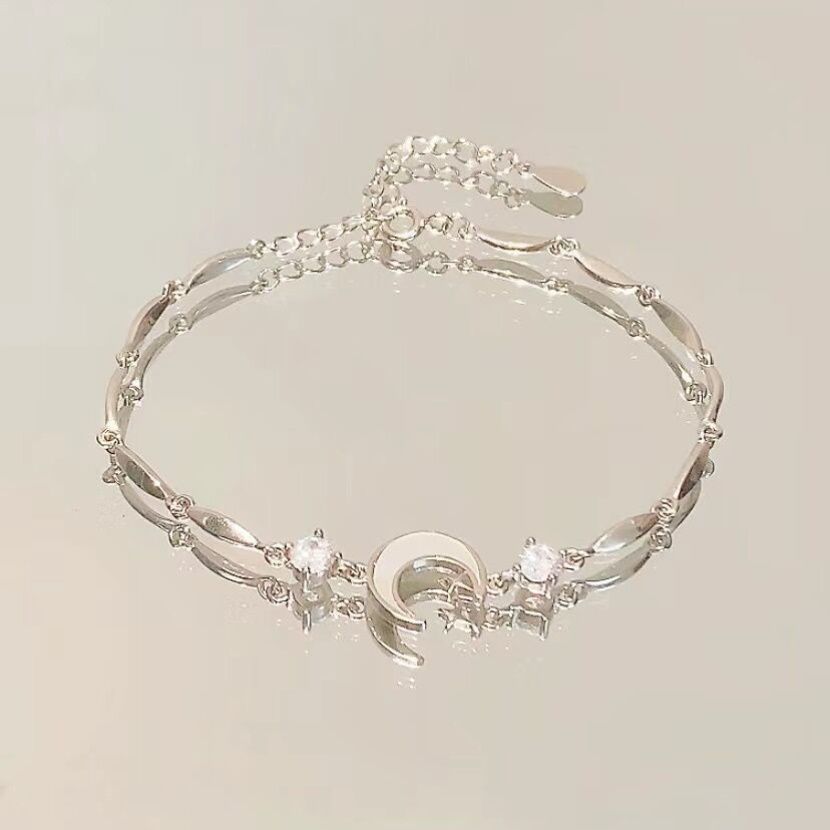 Silver-tone star and moon crystal charm bracelet