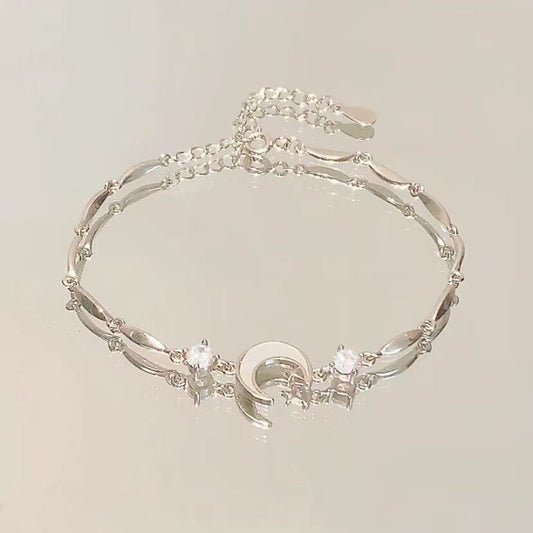 Silver-tone star and moon crystal charm bracelet
