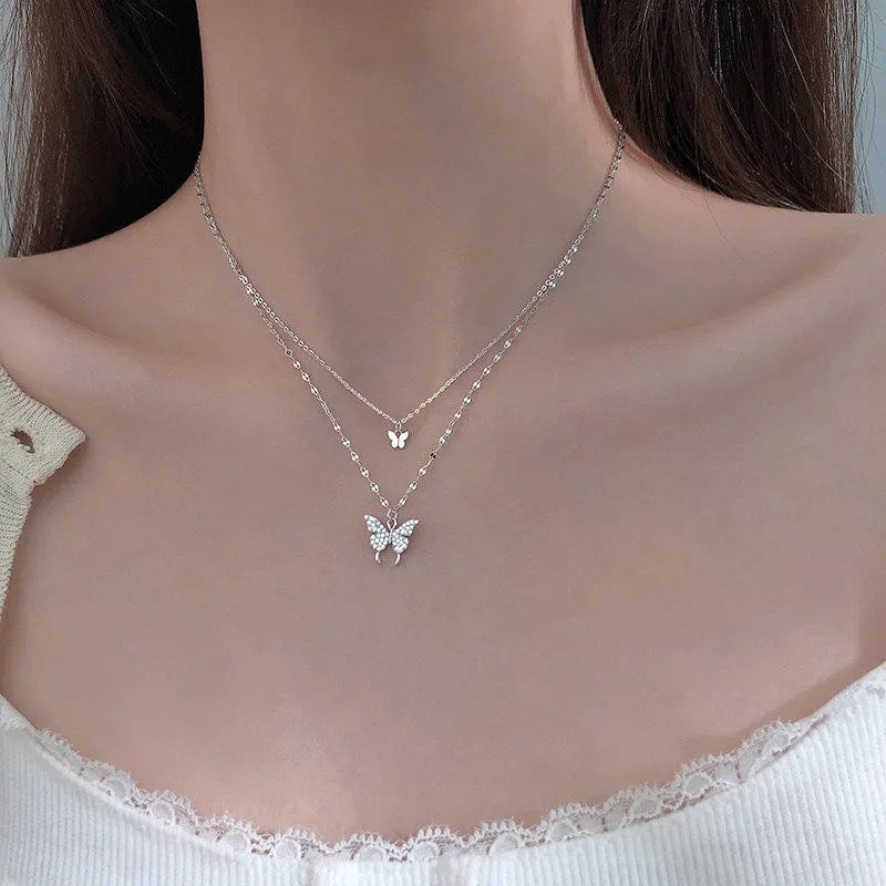 Layered butterfly pendant necklace with delicate chain detail