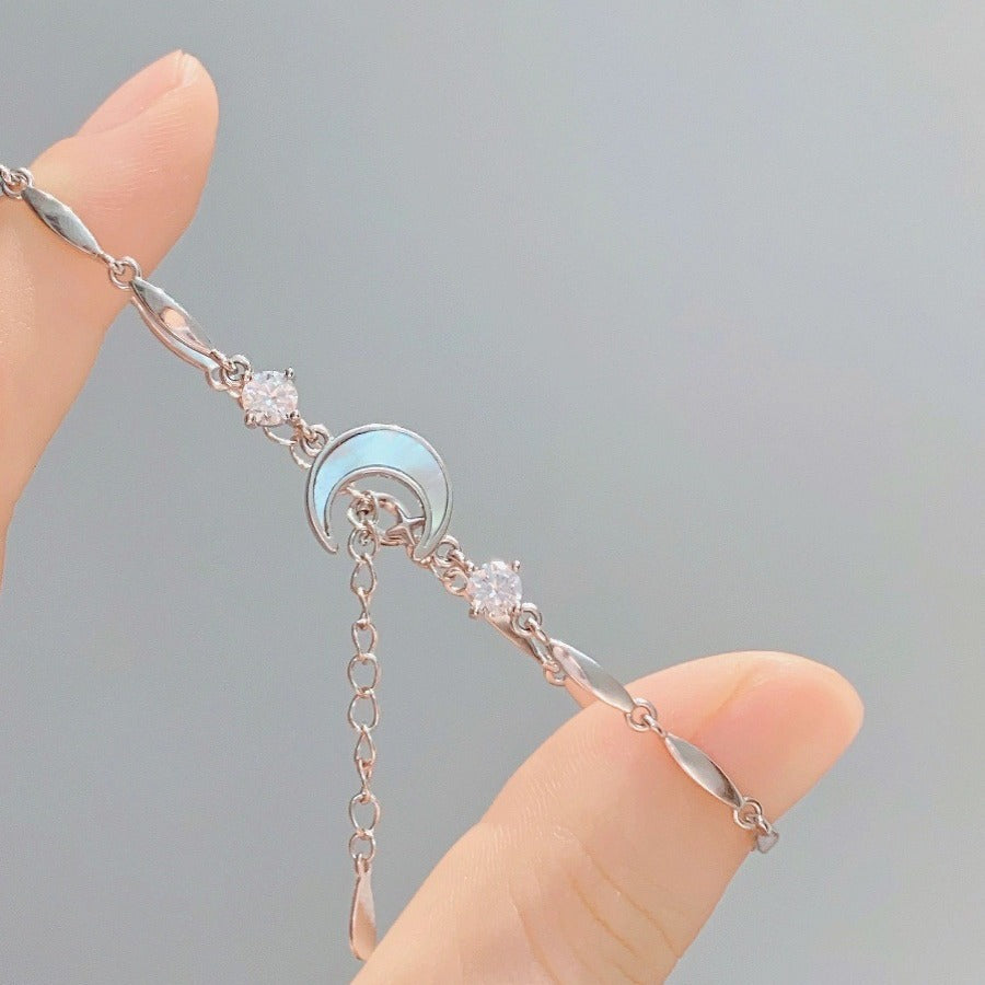 Silver-tone star and moon crystal charm bracelet