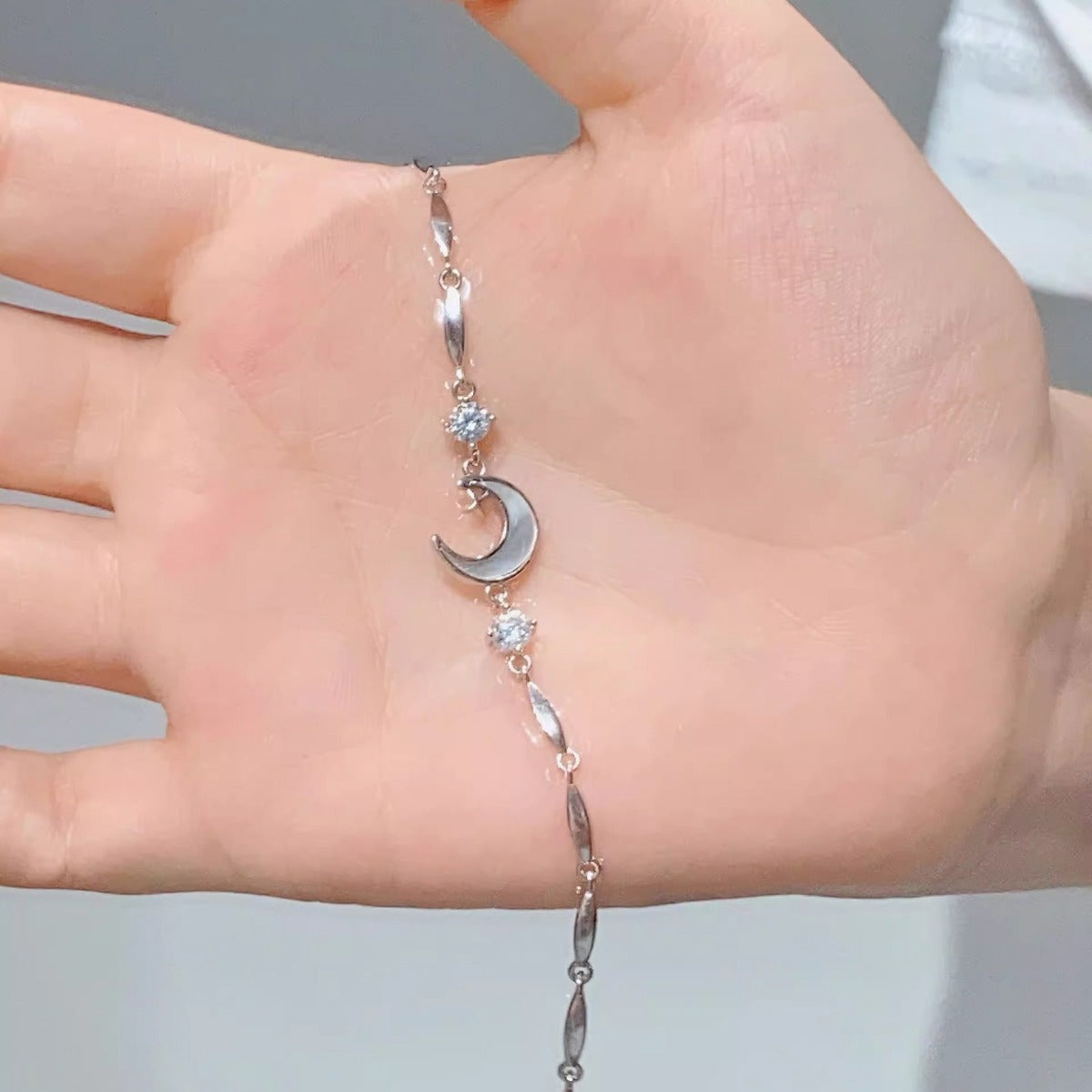 Silver-tone star and moon crystal charm bracelet